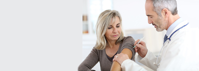 KVB-Teaserbild "Schutzimpfungen" Arzt impft Patientin in den Oberarm